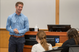 Steve Irlbeck in front of a Paul College speaking with students.